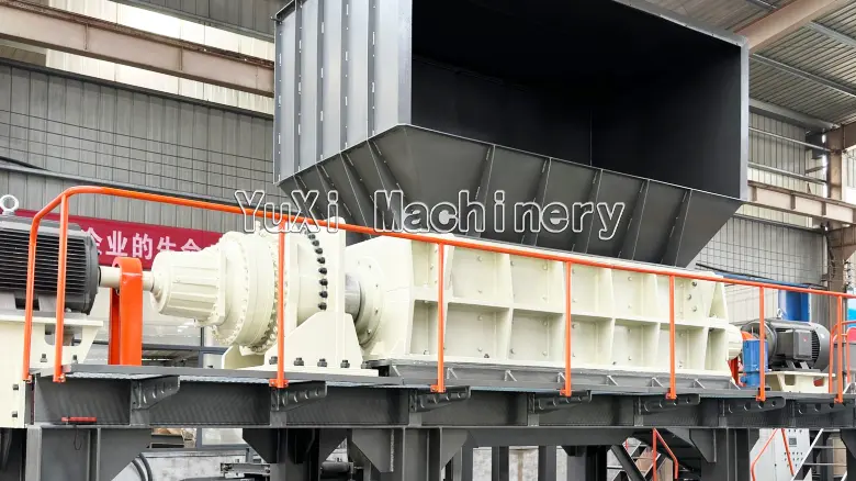 Close-up on the rotor housing, gearbox, and drive motor of the twin shaft shredding equipment.